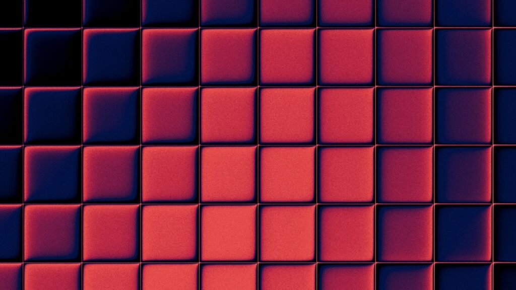 Ein Gitter aus roten und blauen Quadraten mit Schattenwurf, abstrakt fotografiert auf unsplash.com