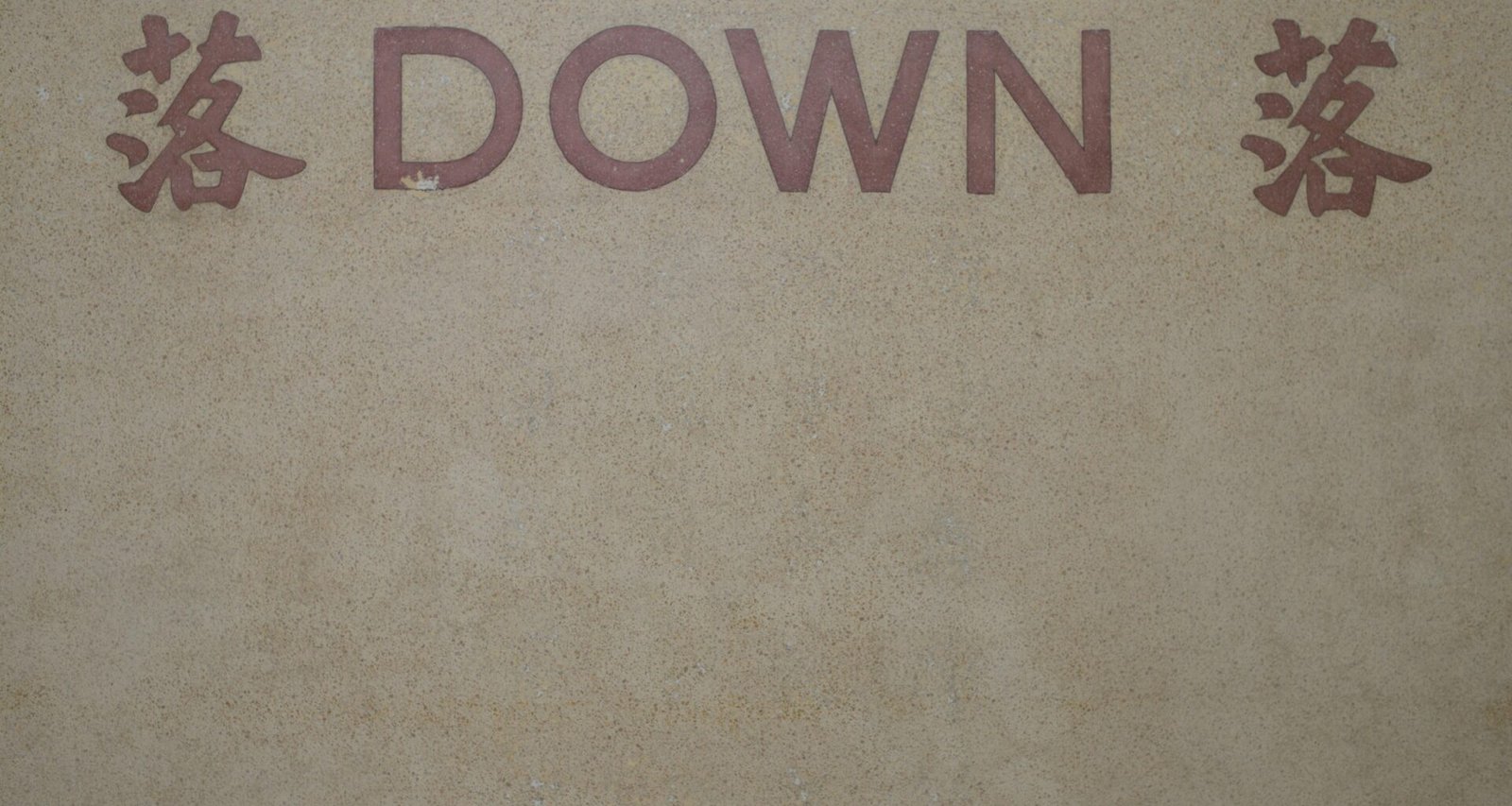 Nahaufnahme eines Schilds an der Fassade eines modernen Gebäudes, fotografiert von Chromatograph.