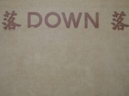 Nahaufnahme eines Schilds an der Fassade eines modernen Gebäudes, fotografiert von Chromatograph.