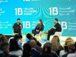 Speaker stehen auf einer großen Bühne beim 1 Billion Followers Summit und diskutieren vor Publikum über Online-Marketing.