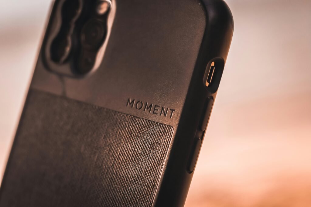 Schwarzes Samsung Galaxy Smartphone liegt auf einem braunen Holztisch, Fokus auf die elegante Erscheinung des Geräts.
